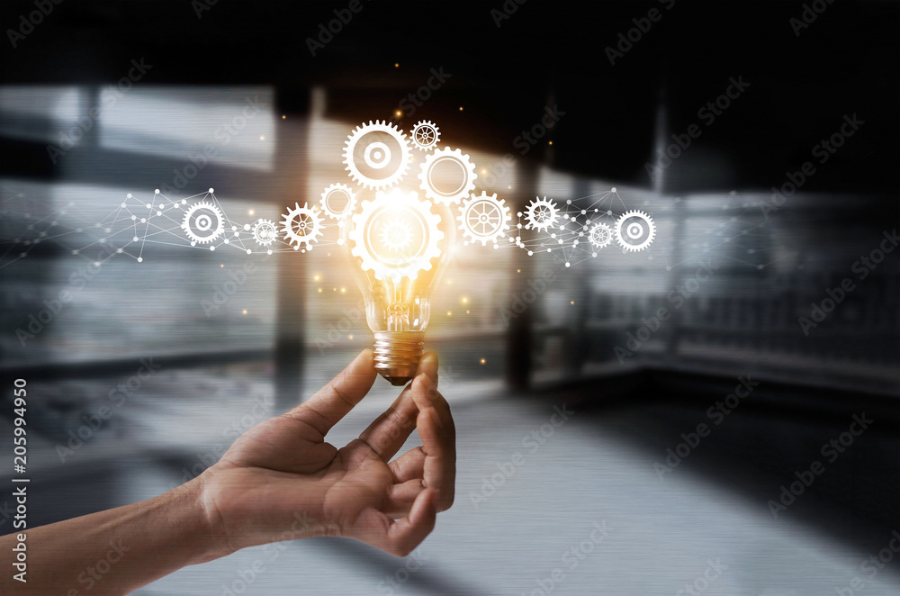 Poster Hand holding light bulb and cog inside. Idea and imagination. Creative and inspiration. Innovation gears icon with network connection on metal texture background. Innovative technology in science