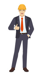 Businessman in construction helmet with hand in pocket  showing thumb up