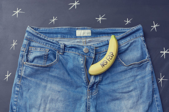 Banana with inscription "nofap" out of jeans like mens penis. Concept sexual problems.