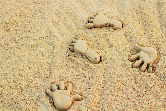 Sand on the beach or in the sandbox and footprints in the sand. Can be used as a background image to copy space.