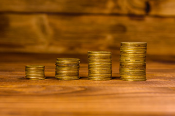 Stack of the coins on wooden table