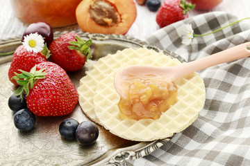 Tasty and healthy breakfast: waffles with fruit jam.