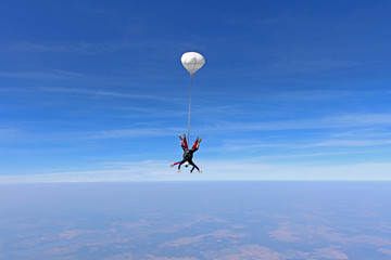 Naklejka na ściany i meble Tandem skydiving. Two men are in the sky.