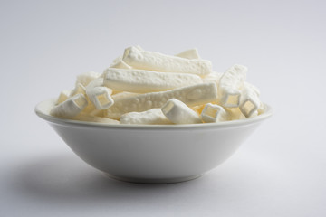 Tilgul Laddu or Til Gul balls for makar sankranti, it's a healthy food made using sesame, crushed peanuts and jaggery. served in a bowl. selective focus showing details.
