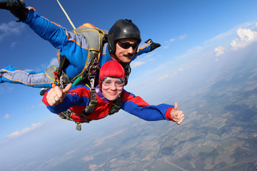 Tandem skydiving. Physically challenged woman is flying in the sky.
