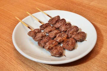 Skewered and grilled chicken hearts    
