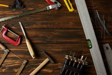 elevated view of different tools on brown wooden tabletop