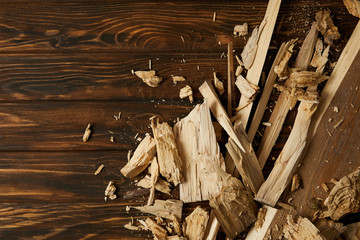 elevated view of wooden chips and pieces on brown tabletop