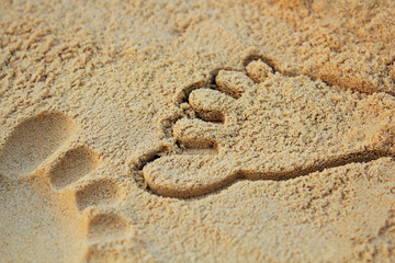 Fototapeta na wymiar Sand on the beach or in the sandbox and footprints in the sand. Can be used as a background image to copy space.