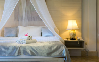 Bed and nightstand in modern bedroom and equipment for a comfortable and restful experience.