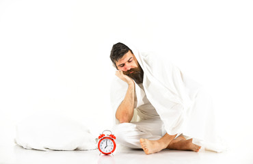 Man wants to stay in bed, white background.