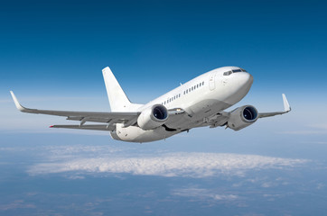 Fototapeta na wymiar Passenger airplane flying at flight level high in the sky above the clouds.