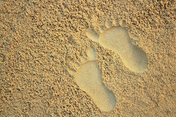 Sand on the beach or in the sandbox and footprints in the sand. Can be used as a background image to copy space.