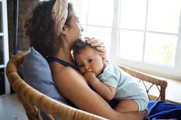 Sideways shot of beautiful casually dressed young Hispanic woman enjoying sweet happy moments of...