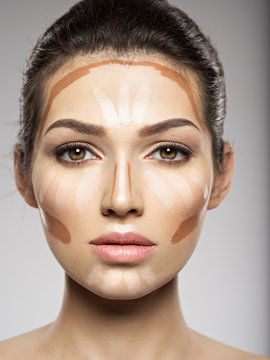 Cosmetic makeup tonal foundation is on woman's face.