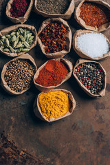 top view of indian spices in paper bags on table
