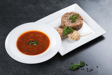 Complex dinner. Buckwheat porridge with dietary meat on a white plate is tenderly served