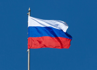 Flag of the Russian Federation against the blue sky