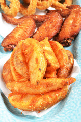  A snack platter with Fried onion rings, fried cheese balls and sauce
