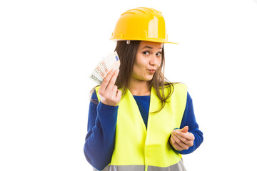 Young woman engineer holding salary.