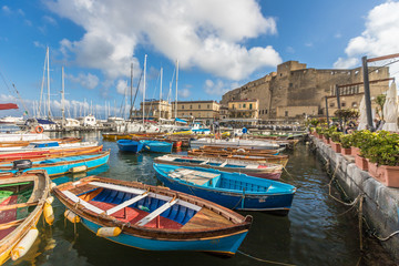 Fototapeta na wymiar Boats near new castle in Naples Italy