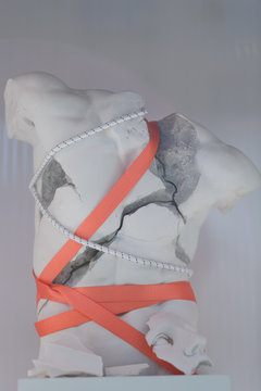 Tied up with cord broken gypsum torso as a concept of modern art