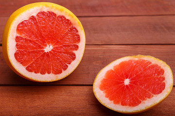 juicy red grapefruit on wooden table