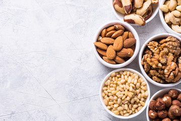 Nuts and dried fruits assortment on stone table top view.