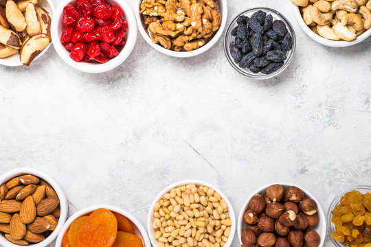 Nuts and dried fruits assortment on stone table top view.