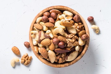 Nuts assortment in a bowl on white top view.