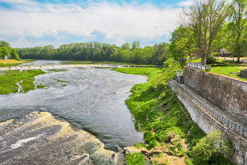 Fototapeta na wymiar Venta rapid, 240 -meter wide natural rapid which is the widest in Europe. Located at the river Venta in the Latvian town Kuldiga.