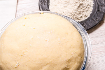 Yeast dough on wooden table.