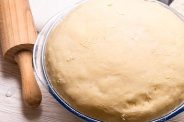Yeast dough on wooden table.