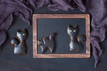 Homemade gingerbread cookies in the form of black cat. Halloween concept
