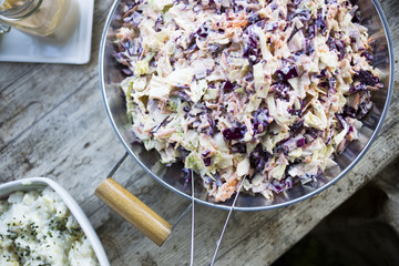birds eye view of coleslaw on natural beige wooden table 
