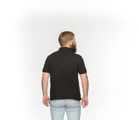 Closeup of young man's body in empty black t-shirt isolated on white background. Mock up for disign concept