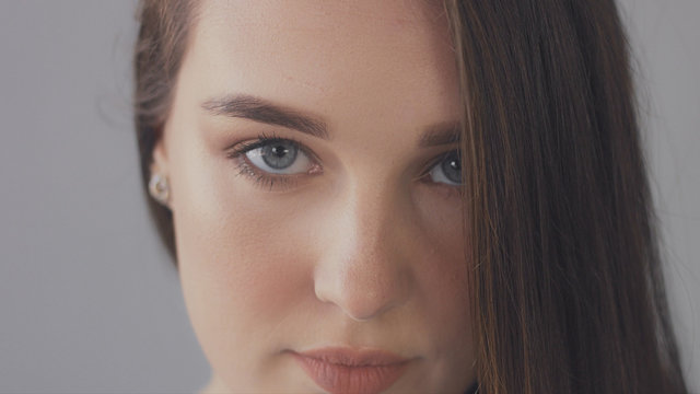 closeup of blue eyes of young woman looking at camera, Studio light ideal strobbing skin highlight