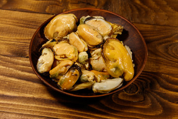 Marinated mussels on wooden table