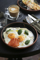 Fried eggs with spinach and salmon