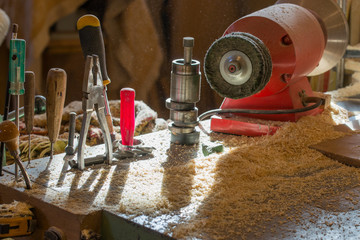 Carpenter tools on wooden table with sawdust