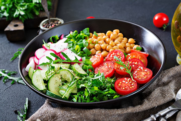 Salad of chickpeas, tomatoes, cucumbers, radish and greens. Dietary food. Vegan salad.