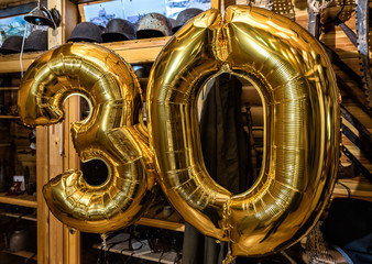 Gold inflatable balls in the form of a figure 30