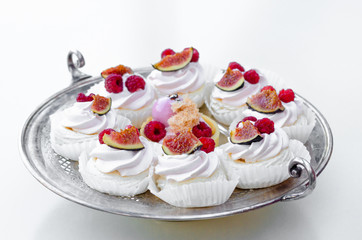  Candy Bar. Delicious homemade dessert meringue with figs and raspberries for christmas or new year on silver plate. Sweet holiday buffet with candies and desserts. 