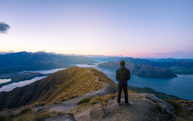 Fototapeta premium A young Asian man enjoying looking at the stunning scenery on the high mountain before sunset.