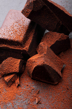 Dark chocolate stack, and powder.Closeup.Chocolate