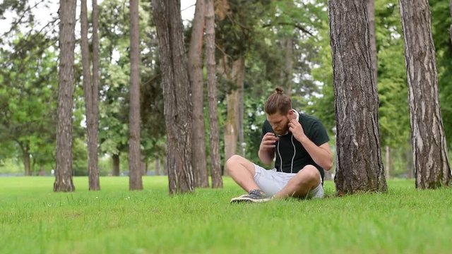 man in park listening music