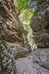 Hikers in a narrow trail of Imbros gorge, Crete, Greece