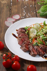 fillet mignon with salad and vegetables slice 