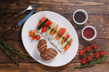 steak with vegetables top view. mignon with pepper and rosemary