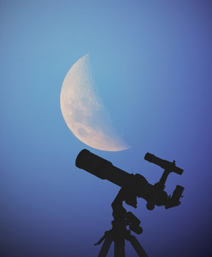 Moon and telescope on a dark-blue background. 